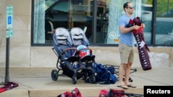 A community member collects his belongings the day after a mass shooting at a Fourth of July parade in the wealthy Chicago suburb of Highland Park, Illinois, U.S. July 5, 2022. (REUTERS/Cheney Orr)