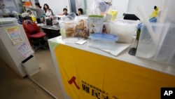 FILE - In this photo taken Dec. 8, 2015, Japan Association for Refugees staff members work at their office in Tokyo. Japanese laws that take effect June 10, 2024, make it easier to deport failed asylum seekers.