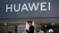 People walk past a Huawei retail store in Beijing, Sunday, June 30, 2019. Once again, Presidents Donald Trump and Xi Jinping have hit the reset button in trade talks between the world's two biggest economies, at least delaying an escalation in…