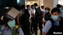 Police officers stop and search demonstrators during a protest after China's parliament passes a national security law for Hong Kong, in Hong Kong, June 30, 2020. 