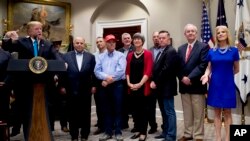 President Donald Trump, during a White House announcement about aid to U.S. farmers and ranchers, asks presidential counselor Kellyanne Conway, right, how his demeanor was during a recent infrastructure meeting with House Speaker Nancy Pelosi and Democratic leaders, May 23, 2019.