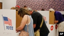 FILE - People vote at the Oklahoma County Board of Elections in Oklahoma City.