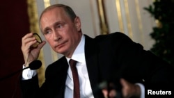 Russia's President Vladimir Putin attends a news conference in Vienna, June 24, 2014.