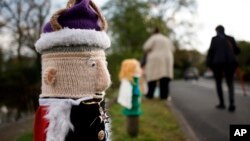 A knitted figure of Britain's King Charles III covers a post following its placement by members of the 'Hurst Hookers' knitting group during a pre-coronation 'yarn bombing' in the village of Hurst, near Reading, England, April 21, 2023. 