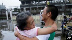 An elderly woman is carried to a vehicle as they go to an evacuation center in Marawi city, southern Philippines on Thursday, June 8, 2017.