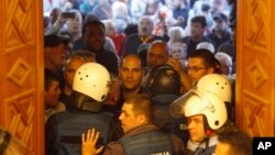 Police try to block protestors as they enter into the parliament building in Skopje, Macedonia, April 27, 2017. Scores of protesters have broken through a police cordon and entered Macedonian parliament to protest the election of a new speaker despite a m