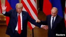 U.S. President Donald Trump and Russian President Vladimir Putin react at the end of the joint news conference after their meeting in Helsinki, Finland, July 16, 2018. 