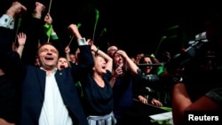 Leader of environmental MDG party Une Bastholm (right) and Arild Hermstad (left) cheer over the proviosional figures of local elections, in Oslo, Norway, Sept. 9, 2019.