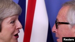FILE - British Prime Minister Theresa May meets with European Commission President Jean-Claude Juncker to discuss Brexit, at the EU headquarters in Brussels, Dec. 11, 2018.