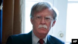 National Security Adviser John Bolton listens as President Donald Trump speaks during a Cabinet meeting at the White House in Washington, April 9, 2018.