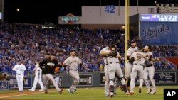 San Francisco Giants players celebrate after Game 7 of baseball's World Series against the Kansas City Royals Wednesday, Oct. 29, 2014.