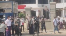 Police officers hold riffles as they continue to disperse protesters outside the No. 1 Basic Education High School, in Myawaddy, Myanmar, Feb. 7, 2021 in this still image obtained from a video.
