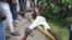 IA injured men lies on the ground after clashed with police at a market in the Abobo neighborhood in Abidjan, October 15, 2012.