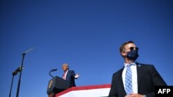 A U.S. secret service agent stands guard as US President Donald Trump speaks during a rally at Prescott Regional Airport in Prescott, Arizona on Oct. 19, 2020.A U.S. secret service agent stands guard as US President Donald Trump speaks during a rally at P