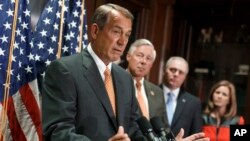 House Speaker John Boehner of Ohio, left, speaks during a news conference on Capitol Hill in Washington, Sept. 9, 2014. 