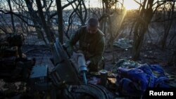 A Ukrainian serviceman prepares tank munitions for upload, amid Russia's invasion of Ukraine, in the country's eastern Luhansk region, Feb. 18, 2024.