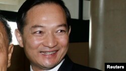 FILE - Zhang Kunsheng leaves a hotel in Hanoi, November 18, 2006. 