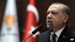 Turkey's president and leader of ruling Justice and Development Party, Recep Tayyip Erdogan, addresses supporters and lawmakers at the parliament in Ankara, Turkey, Jan. 9, 2018. 