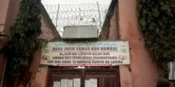 FILE - A sign is seen above a house where police rescued men and boys in Kaduna, Nigeria, Sept. 27, 2019. The sign reads: "Imam Ahmad Bun Hambal center for Islamic studies."
