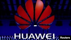 FILE - The Huawei logo is seen during the Mobile World Congress in Barcelona, Spain, Feb. 26, 2018.