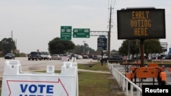 FILE - Signs are seen outside of a polling location during early voting in Sumter, South Carolina, Oct. 9, 2020.