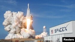 FILE - A SpaceX Falcon Heavy rocket lifts off from historic launch pad 39-A at the Kennedy Space Center in Cape Canaveral, Florida, Feb. 6, 2018. 