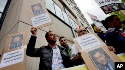 Men protest to support the release of the journalist Ahmed Mansour in Berlin, Germany, Sunday, June 21, 2015. Mansour, 52, a senior journalist with the Qatar-based broadcaster Al-Jazeera, was detained at Tegel airport on Saturday on an Egyptian arrest warrant.
