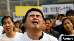 马来西亚驻华大使馆前有失踪乘客家属哭泣，喊口号