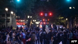 People protest in front of the Multnomah County Justice Center in Portland, Oregon, on July 17, 2020.
