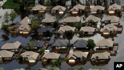 Homes are surrounded by water from the flooded Brazos River in the aftermath of Hurricane Harvey, in Freeport, Texas, Sept. 1, 2017.