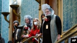People are seen in the House gallery as protesters try to break into the House Chamber at the U.S. Capitol on Wednesday, Jan. 6, 2021, in Washington. (AP Photo/Andrew Harnik)