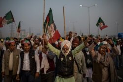 Indian farmers shout slogans as they block a major highway during a protest against new farm laws at the Delhi-Uttar Pradesh state border, India, on Dec. 5, 2020.