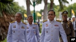 Thailand Prime Minister Prayuth Chan-ocha, second right walks to attend a cabinet meeting with aides and at the Government House of Thailand in Bangkok, Thailand, Tuesday, Aug. 27, 2019. Prayuth Chan-ocha omitted a sentence in the oath of office…