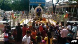 Indian devotees gather at the Shani Shingnapur Temple in Ahmednagar, some 200 kilometers east of Mumbai, April 2, 2016. Angry villagers blocked a group of women activists from entering the inner sanctum of the temple.