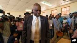 FILE - Botswana President Mokgweetsi Masisi arrives to vote in Botswana's general elections in Moshupa, Botswana. 