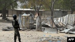 FILE - A picture taken on February 17, 2015 shows a Cameroonian soldier walking in the Cameroonian town of Fotokol, on the border with Nigeria, after clashes occurred on Feb. 4 between Cameroonian troops and Nigeria-based Boko Haram insurgents. 