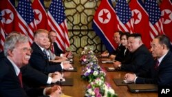 FILE - President Donald Trump speaks during a meeting with North Korean leader Kim Jong Un, in Hanoi, Vietnam, Feb. 28, 2019. At left is then-National Security Adviser John Bolton.