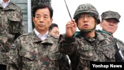 한민구 한국 국방장관(왼쪽)이 4일 중동부 전선의 최전방 부대를 방문해 군사대비태세를 점검하고 있다.