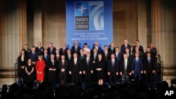 Foreign Ministers from NATO countries pose for a group photo during a ceremony to commemorate NATO's 70th anniversary at Mellon Auditorium in Washington, Wednesday, April 3, 2019. 