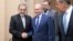 Russian President Vladimir Putin, center, shakes hands with Ali Akbar Velayati, a senior adviser to Iran's Supreme Leader Ayatollah Ali Khamenei, as Russian Foreign Minister Sergey Lavrov, stands at right, at Novo-Ograyovo outside in Moscow, Russia, July 12, 2018. 