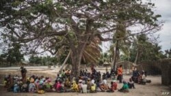 Residents gather for a meeting in the recently attacked village of Aldeia da Paz outside Macomia, on August 24, 2019.
