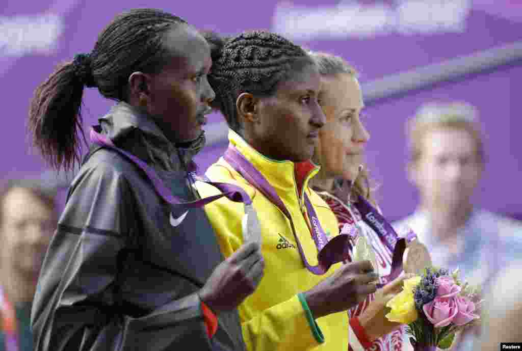 Ethiopia&#39;s gold medal winner Tiki Gelana, right, Kenya&#39;s silver medal winner Priscah Jeptoo, left, and Russia&#39;s bronze medalist Tatyana Petrova Arkhipova during the ceremony for the women&#39;s marathon at 2012 Summer Olympics, August 5, 2012.