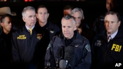 Austin Police Chief Brian Manley, center, stands with other members of law enforcement as he briefs the media, March 21, 2018, in the Austin suburb of Round Rock, Texas. 