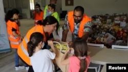 Children donate food to provide support to residents of Beirut, following Tuesday's blast, in Nicosia, Cyprus, Aug. 7, 2020.
