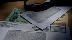 FILE - A stimulus check issued by the Internal Revenue Service to help combat the adverse economic effects of the coronavirus pandemic is seen in San Antonio, Texas, April 23, 2020.