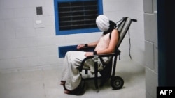 This frame grab from Australian Broadcasting Corporation's (ABC) Four Corners program broadcast in Australia on July 25, 2016 and released on July 26, 2016 allegedly shows a teenage boy hooded and strapped into a chair at a youth detention center in the Northern Territory city of Darwin.