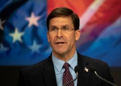 FILE - U.S. Defense Secretary Mark T. Esper delivers remarks before ringing the closing NASDAQ bell for Veterans Day in New York, New York, Nov. 11, 2019.
