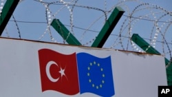 FILE - Barbed wires surround a deportation center in Pehlivankoy, Kirklareli, Turkey, April 4, 2016.