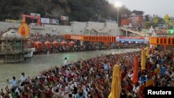 Devotees gather on the banks of Ganges river to pray ahead of the first Shahi Snan at "Kumbh Mela" or the Pitcher Festival, in Haridwar, India, March 10, 2021.