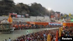 Devotees gather on the banks of Ganges river to pray ahead of the first Shahi Snan at "Kumbh Mela" or the Pitcher Festival, in Haridwar, India, March 10, 2021.